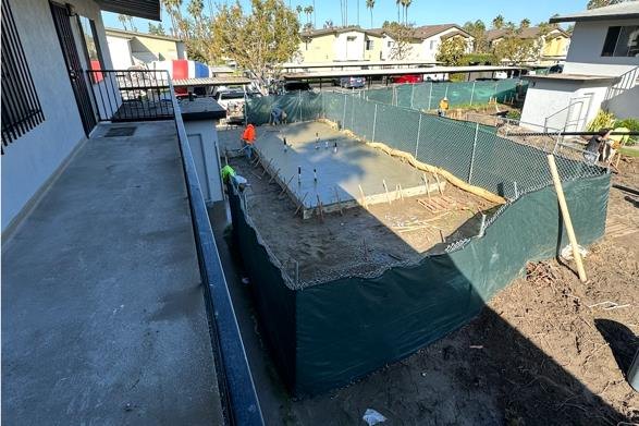 Excavated lot with foundation forms for new ADUs