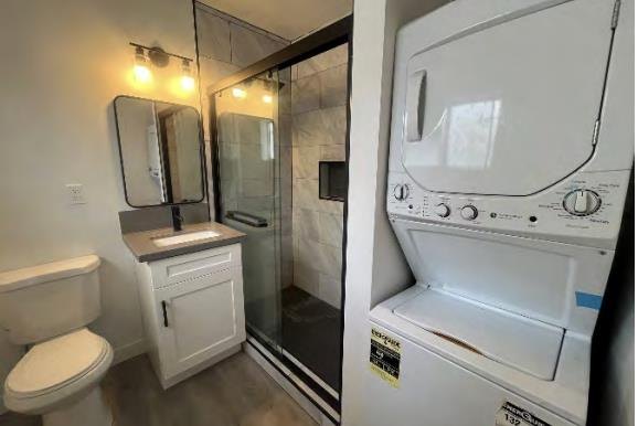 Renovated bathroom with glass shower and in-unit washer and dryer